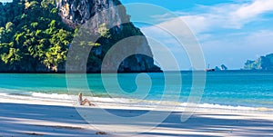 Woman resting on Railay beach Krabi Thailand. Asia