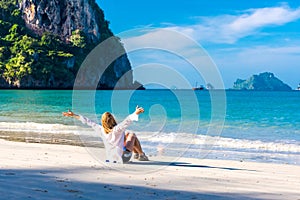 Woman resting on Railay beach Krabi Thailand. Asia