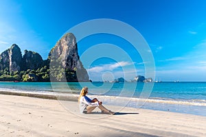 Woman resting on Railay beach Krabi Thailand. Asia