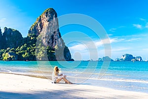 Woman resting on Railay beach Krabi Thailand. Asia