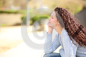 Woman resting and relaxing with eyes closed in a park