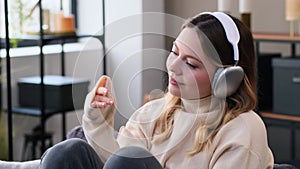 Woman Resting On Sofa And Listening Music At Home