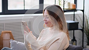 Woman Resting On Sofa With Mobile Phone