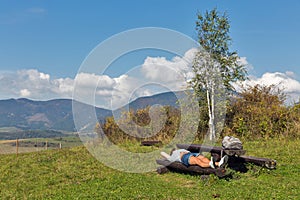 Woman resting on summer hill near Liptovsky Trnovec, Slovakia.