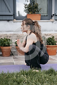Woman in restorative yoga squat pose