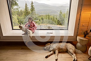 Woman rests in house on nature
