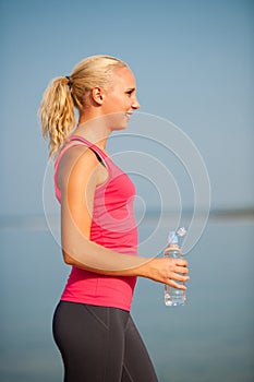 Woman rests after morning workout on the beach