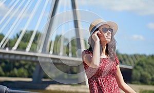 Woman rests on the river in the city. Background bridge