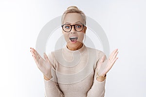 Woman retelling incredible news gesturing feeling excited and upbeat during story smiling talking passionetely posing