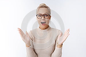 Woman retelling incredible news gesturing feeling excited and upbeat during story smiling talking passionetely posing photo