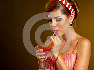 Woman in retro style drinks bloody Mary cocktail