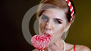 Woman retro style lick lollipop confection portrait