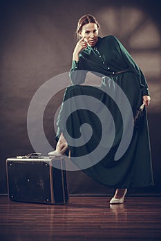 Woman retro style with old suitcase and fan