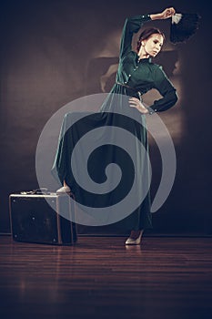 Woman retro style with old suitcase and fan