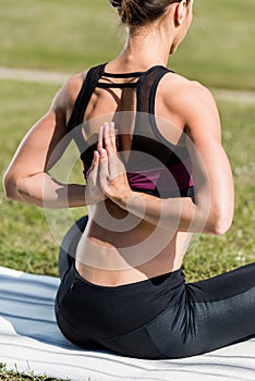 woman in reverse prayer pose practicing