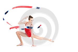 Woman rhythmic gymnast stretching with colorful rope and looking away