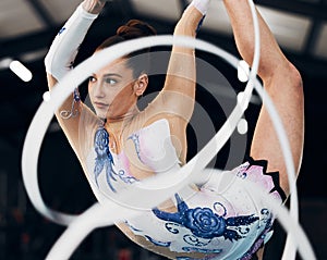 Woman, ribbon gymnastics and dancing for sports performance, competition and concert in arena. Dancer, rhythm and