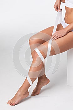 Woman with ribbon on leg