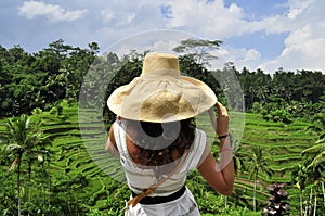 Woman in rice field in Bali, luxury relaxation