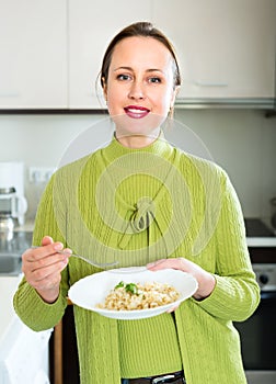 Woman with rice in kitchen