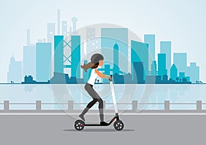 Woman ride electric scooter in a cityscape background photo