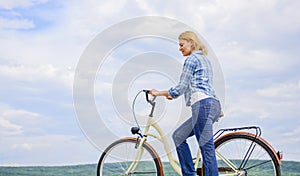 Woman rides bicycle sky background. How to learn to ride bike as an adult. Active leisure. Girl ride bicycle. Healthiest