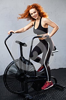 Woman riding the air bike