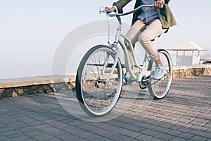 woman is riding a beautiful bicycle along the sea