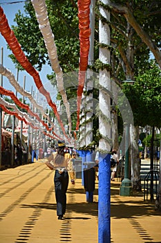 The woman riding, beautiful and elegant walking through the Feria