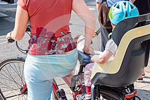 Woman is riding a bicycle with child