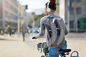 Woman riding bicycle on city street