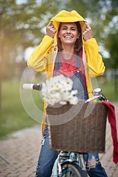 Woman riding bicycle on a rainy day