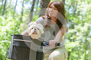 Woman riding a bike with her dog