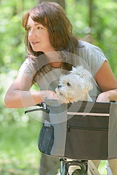 Woman riding a bike with her dog