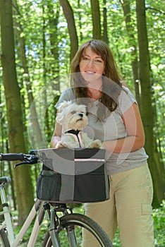 Woman riding a bike with her dog