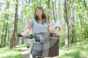 Woman riding a bike with her dog