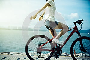 Woman riding a bike on sunny seaside