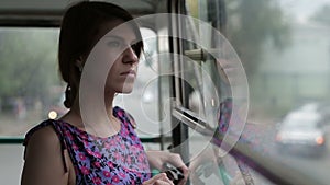 Woman riding in a bus and looking in window