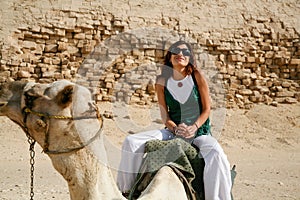 Woman riding camel