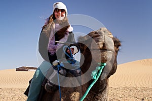 Woman riding a camel