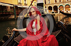 Woman riding gondola on Venice canal