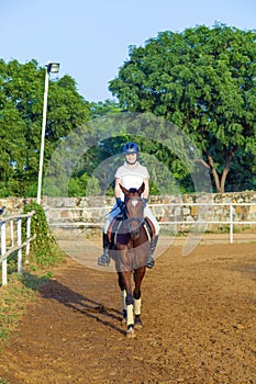 Woman riding her horse
