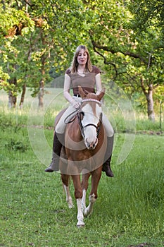 Woman riding her horse bareback