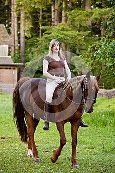 Woman riding her horse bareback