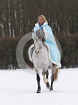 Woman Riding Horse in the Snow