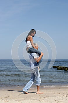 Woman riding on man's shoulders