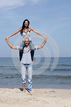 Woman riding on man's shoulders