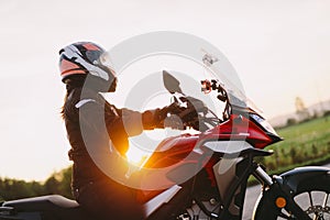 Woman riding motobike at sunset. photo