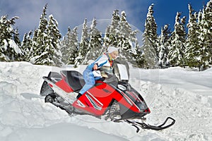 Woman riding a snowmobile