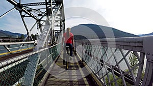 Woman riding unicycle on the bridge 4k